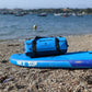 Waterproof duffel bag on paddle board