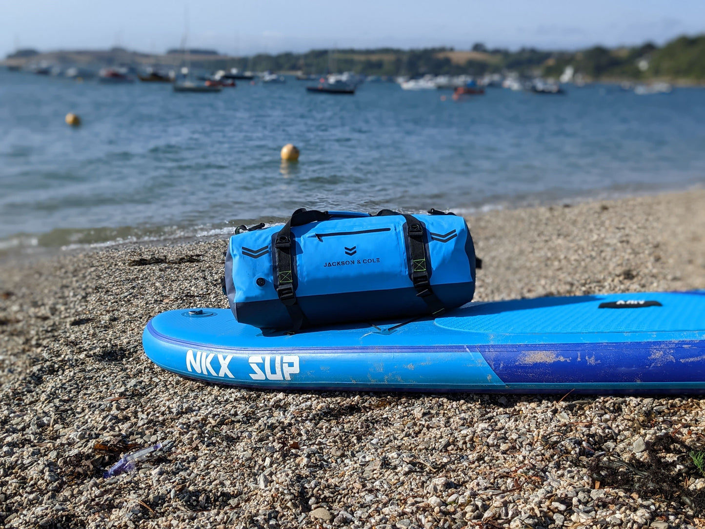 Waterproof duffel bag on paddle board